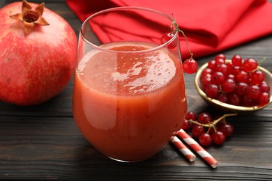 Photo of Superfood. Tasty smoothie in glass and ingredients on wooden table, closeup