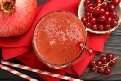 Photo of Superfood. Tasty smoothie in glass and ingredients on wooden table, flat lay