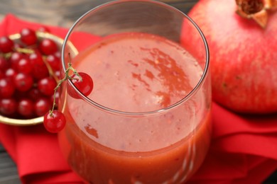 Photo of Superfood. Tasty smoothie in glass and ingredients on table, closeup