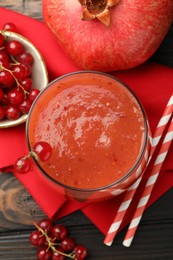 Photo of Superfood. Tasty smoothie in glass and ingredients on wooden table, flat lay