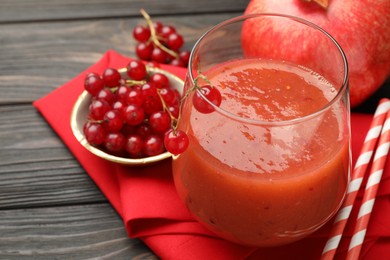 Photo of Superfood. Tasty smoothie in glass and ingredients on wooden table, closeup