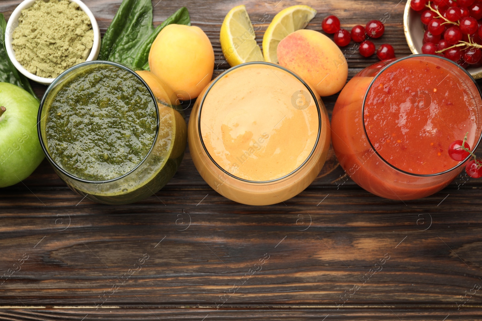 Superfood. Tasty smoothies in glasses and ingredients on wooden table, flat lay. Space for text Photo of Superfood. Tasty smoothies in glasses and ingredients on wooden table, flat lay. Space for text