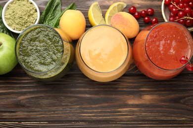 Photo of Superfood. Tasty smoothies in glasses and ingredients on wooden table, flat lay. Space for text