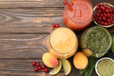 Photo of Superfood. Tasty smoothies in glasses and ingredients on wooden table, flat lay. Space for text