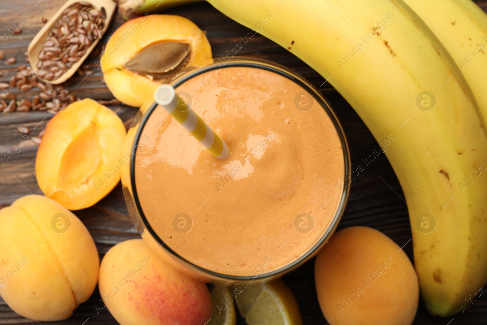 Superfood. Tasty smoothie in glass and ingredients on wooden table, flat lay Photo of Superfood. Tasty smoothie in glass and ingredients on wooden table, flat lay