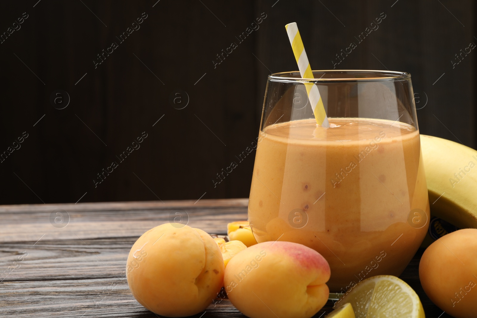 Superfood. Tasty smoothie in glass and ingredients on wooden table, closeup. Space for text Photo of Superfood. Tasty smoothie in glass and ingredients on wooden table, closeup. Space for text