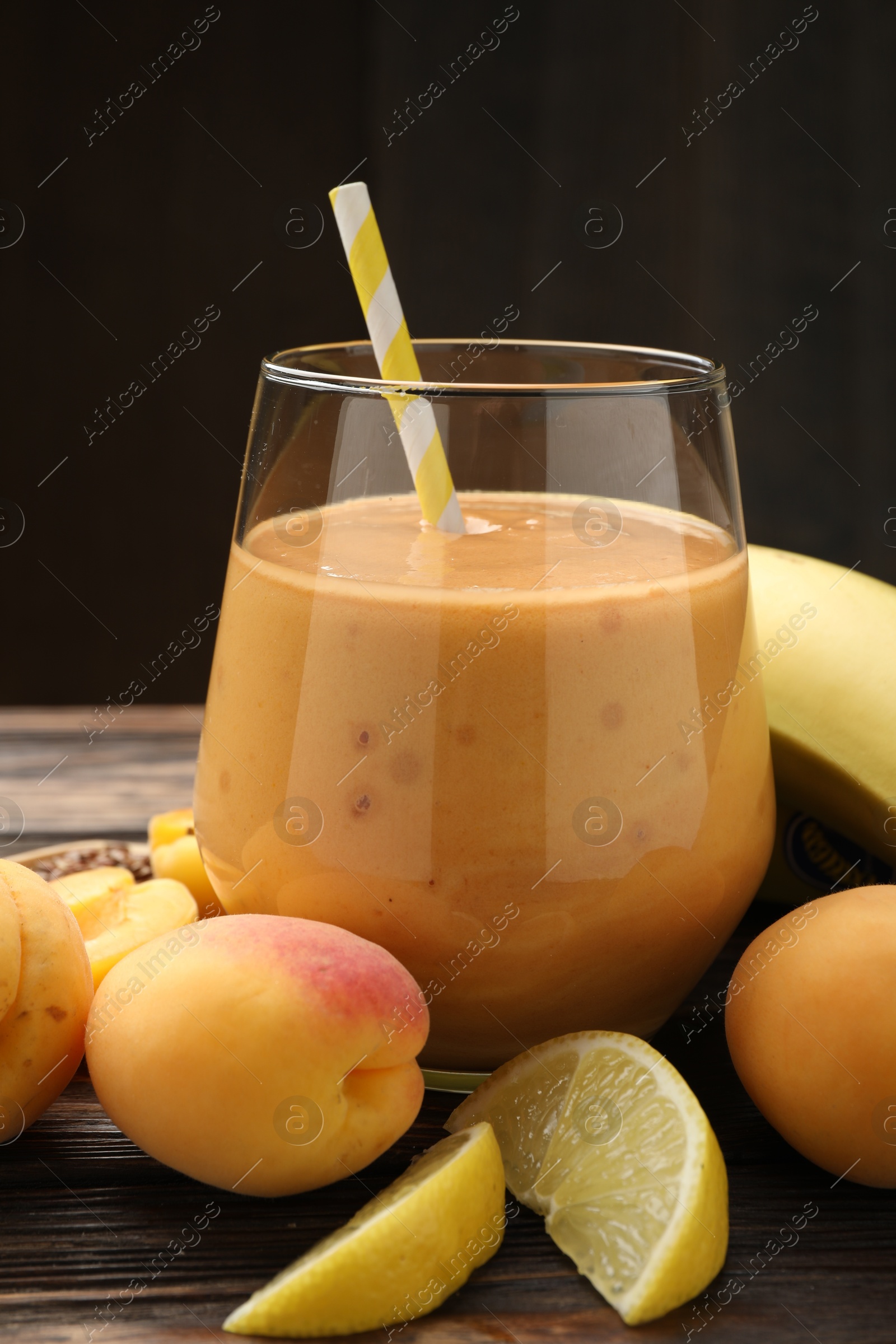 Superfood. Tasty smoothie in glass and ingredients on wooden table, closeup Photo of Superfood. Tasty smoothie in glass and ingredients on wooden table, closeup