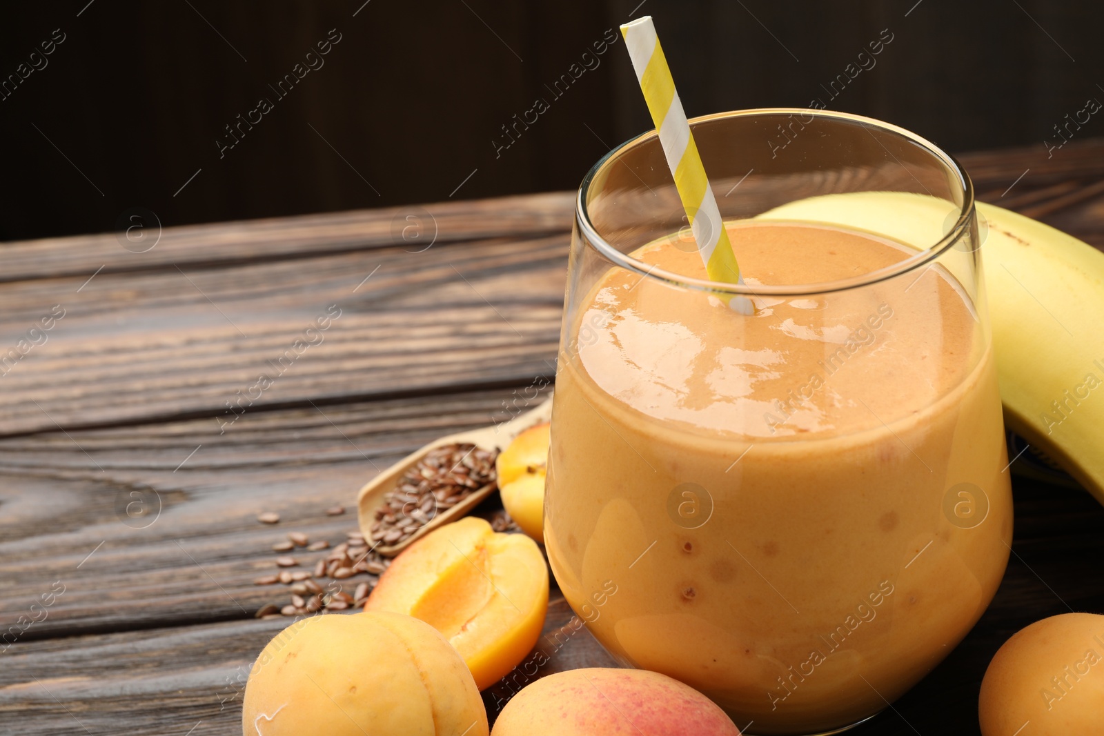 Superfood. Tasty smoothie in glass and ingredients on wooden table, closeup. Space for text Photo of Superfood. Tasty smoothie in glass and ingredients on wooden table, closeup. Space for text