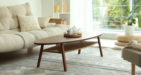 Photo of Coffee table, sofa and decor in dining room. Interior design