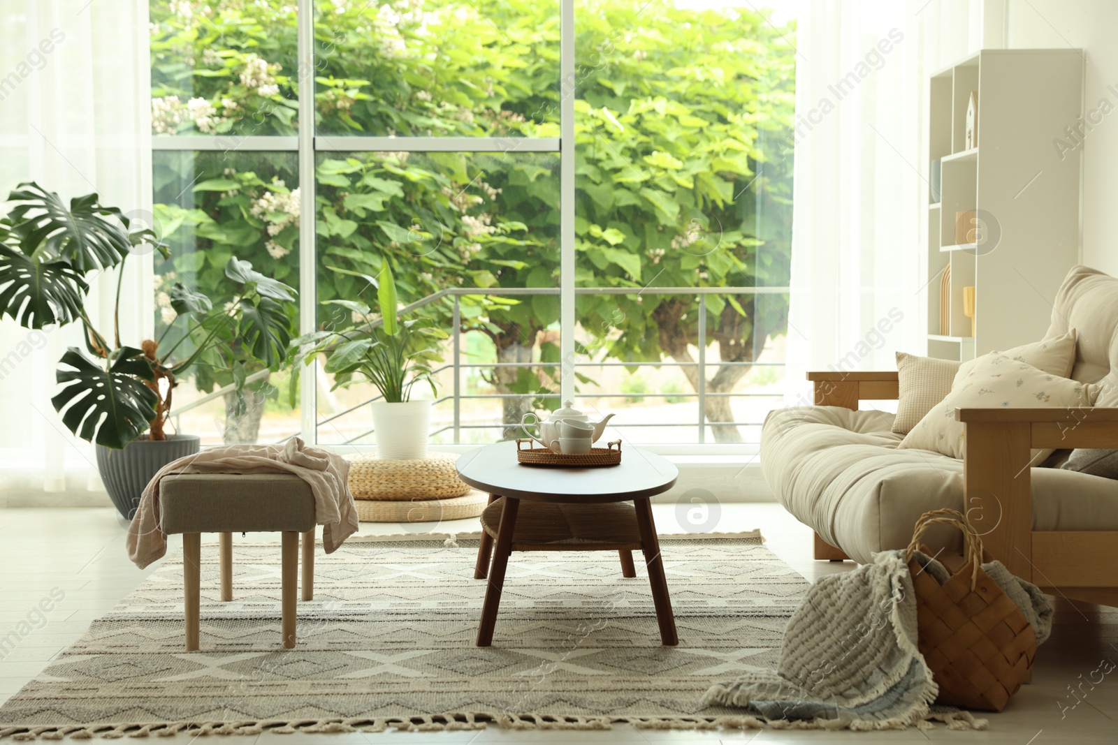 Coffee table, sofa, bench and decor in dining room. Interior design Photo of Coffee table, sofa, bench and decor in dining room. Interior design