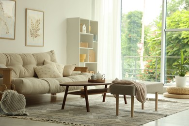 Photo of Coffee table, sofa, bench and decor in dining room. Interior design