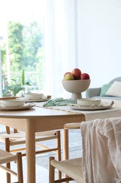 Photo of Stylish table setting, chairs and decor in dining room