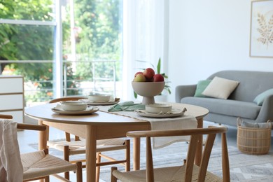 Photo of Stylish table setting, chairs and decor in dining room. Interior design