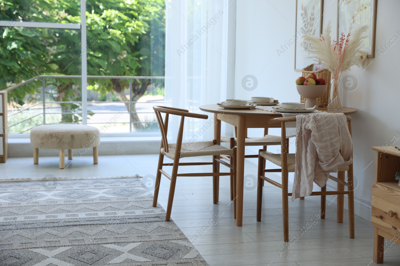 Photo of Stylish table setting, chairs and decor in dining room. Interior design