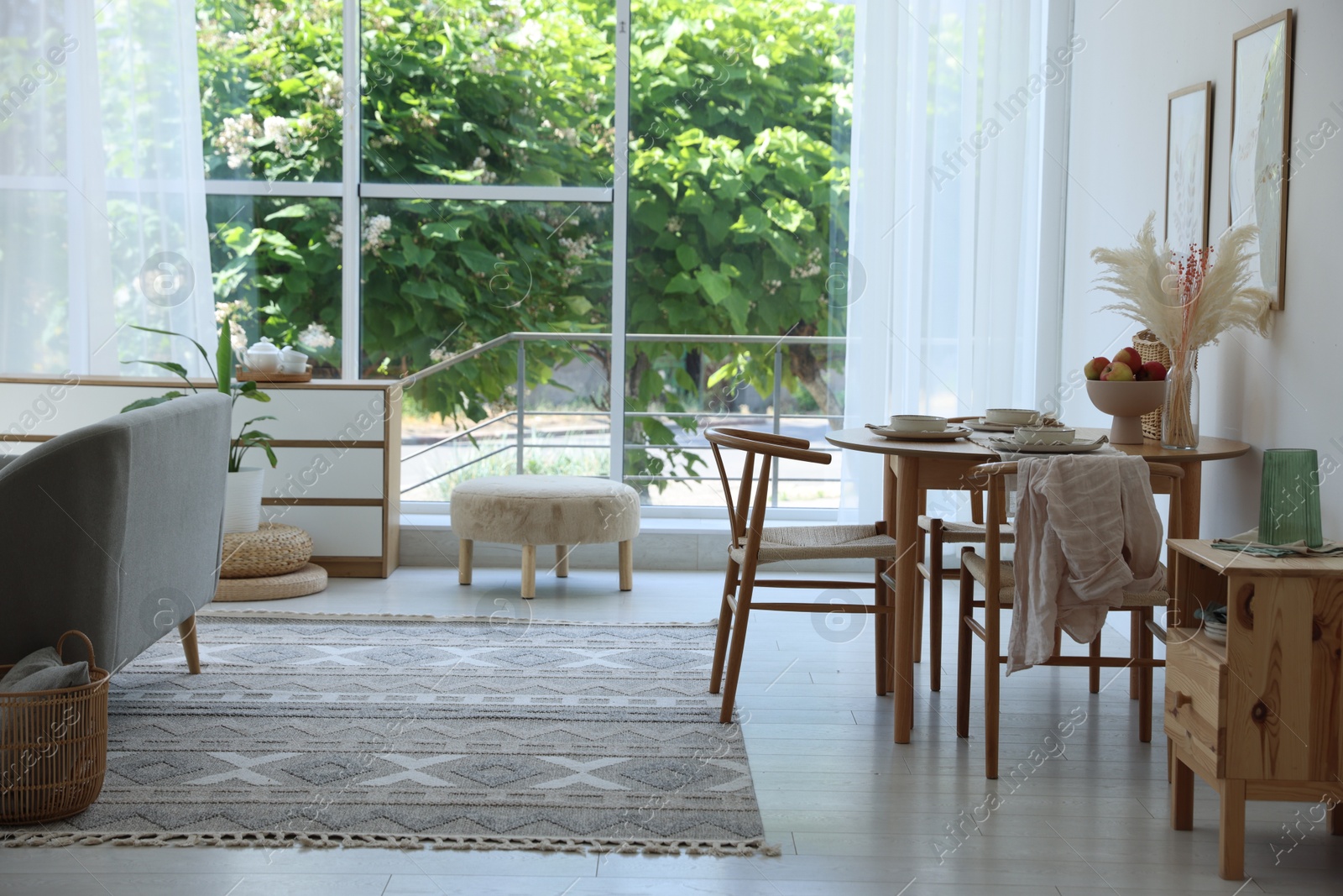 Stylish table setting, chairs and decor in dining room. Interior design Photo of Stylish table setting, chairs and decor in dining room. Interior design