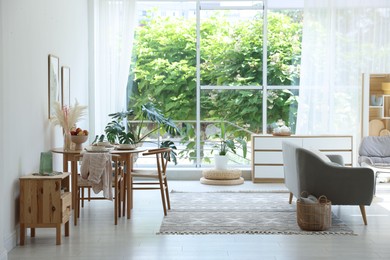Photo of Stylish table setting, chairs, sofa and decor in dining room. Interior design