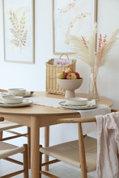 Photo of Beautiful table setting, chairs and decor in dining room. Interior design