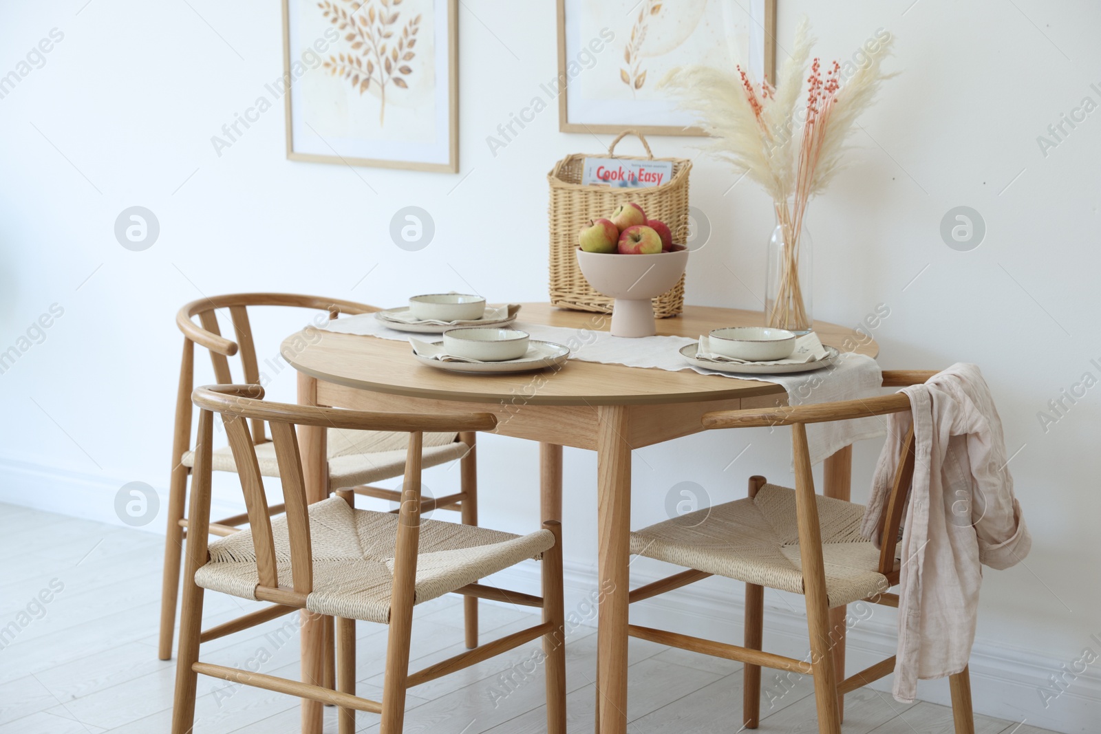 Photo of Beautiful table setting, chairs and decor in dining room. Interior design
