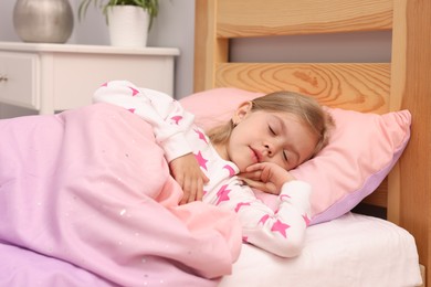 Photo of Little girl sleeping in bed at home
