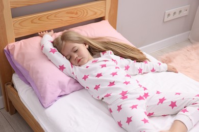 Photo of Little girl sleeping in bed at home