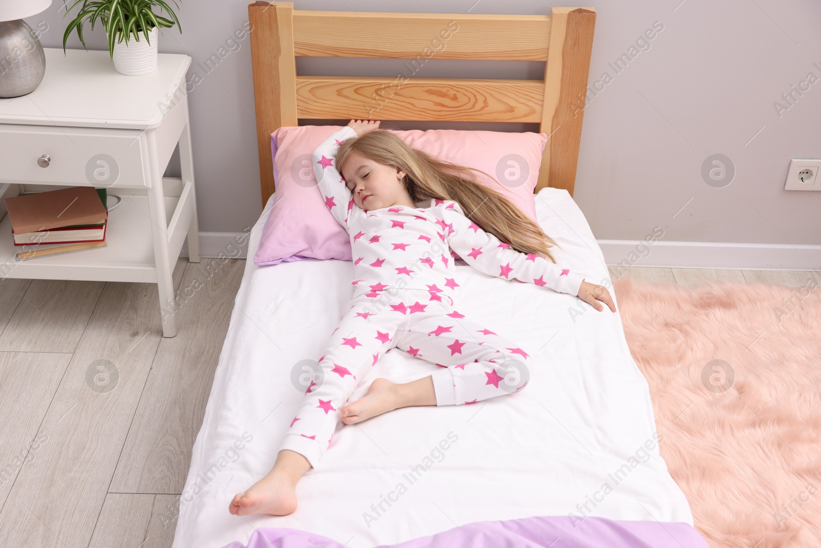 Photo of Little girl sleeping in bed at home