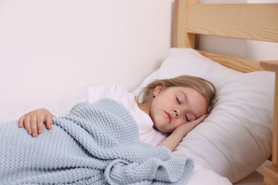 Photo of Little girl sleeping in bed at home