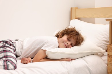 Photo of Little boy sleeping in bed at home