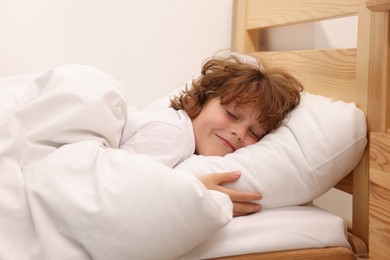 Photo of Little boy sleeping in bed at home