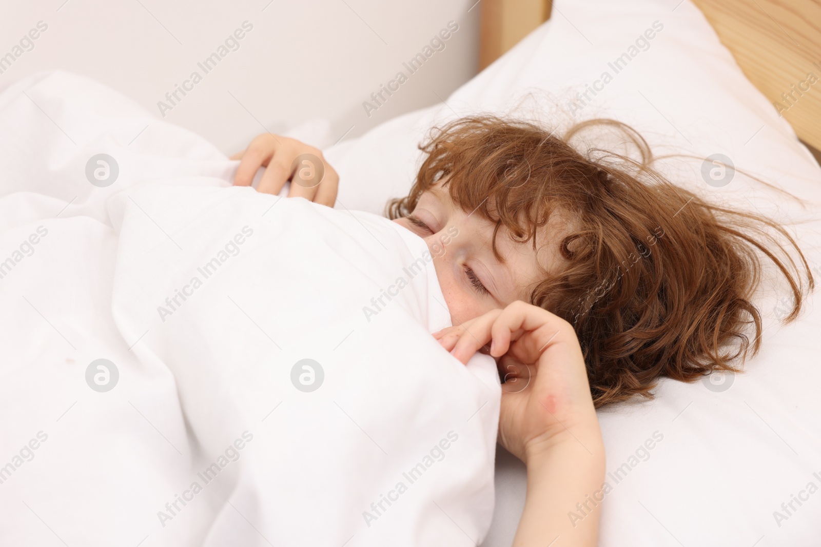Little boy sleeping in bed at home Photo of Little boy sleeping in bed at home