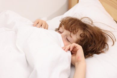 Photo of Little boy sleeping in bed at home