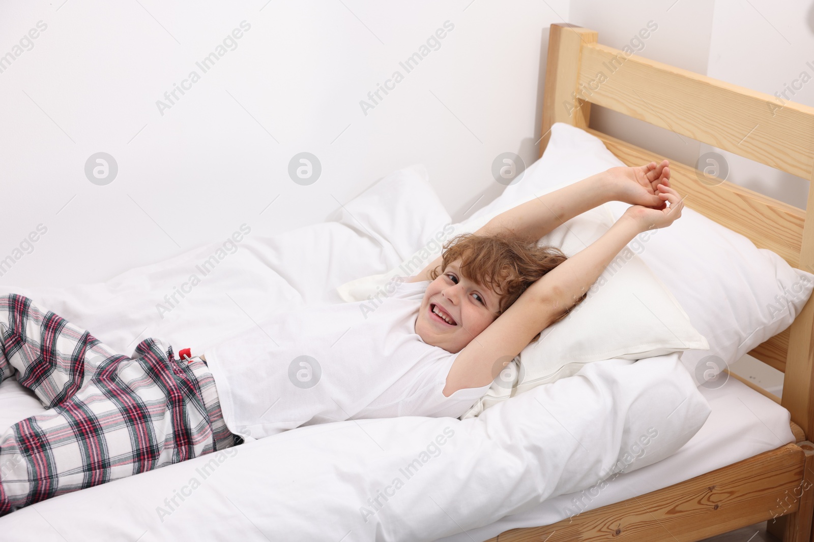 Little boy lying in bed at home Photo of Little boy lying in bed at home