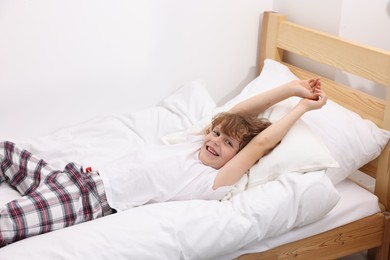 Photo of Little boy lying in bed at home