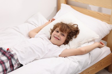 Photo of Little boy lying in bed at home
