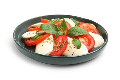 Photo of Tasty salad Caprese with mozzarella, tomatoes, basil and spices isolated on white