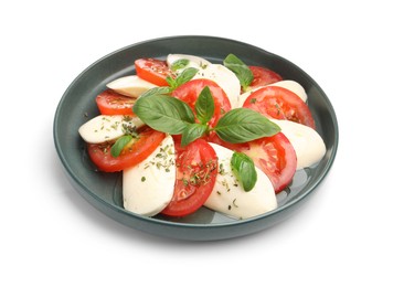 Photo of Tasty salad Caprese with mozzarella, tomatoes, basil and spices isolated on white