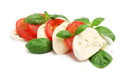 Photo of Tasty salad Caprese with mozzarella, tomatoes, basil and spices isolated on white