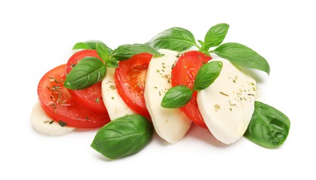 Photo of Tasty salad Caprese with mozzarella, tomatoes, basil and spices isolated on white