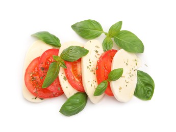 Photo of Tasty salad Caprese with mozzarella, tomatoes, basil and spices isolated on white, top view
