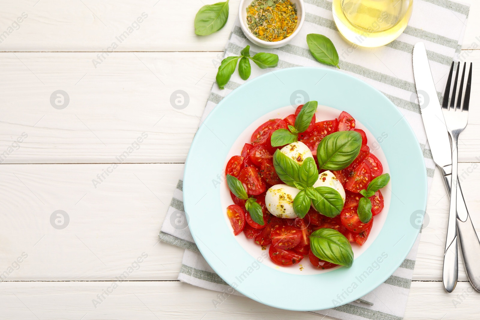 Tasty salad Caprese served on white wooden table, flat lay. Space for text Photo of Tasty salad Caprese served on white wooden table, flat lay. Space for text