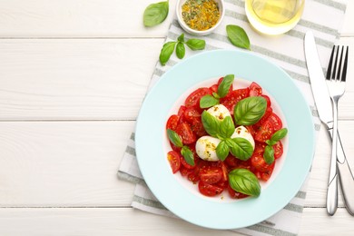 Photo of Tasty salad Caprese served on white wooden table, flat lay. Space for text