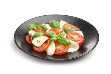 Photo of Tasty salad Caprese with mozzarella, tomatoes, basil and spices isolated on white