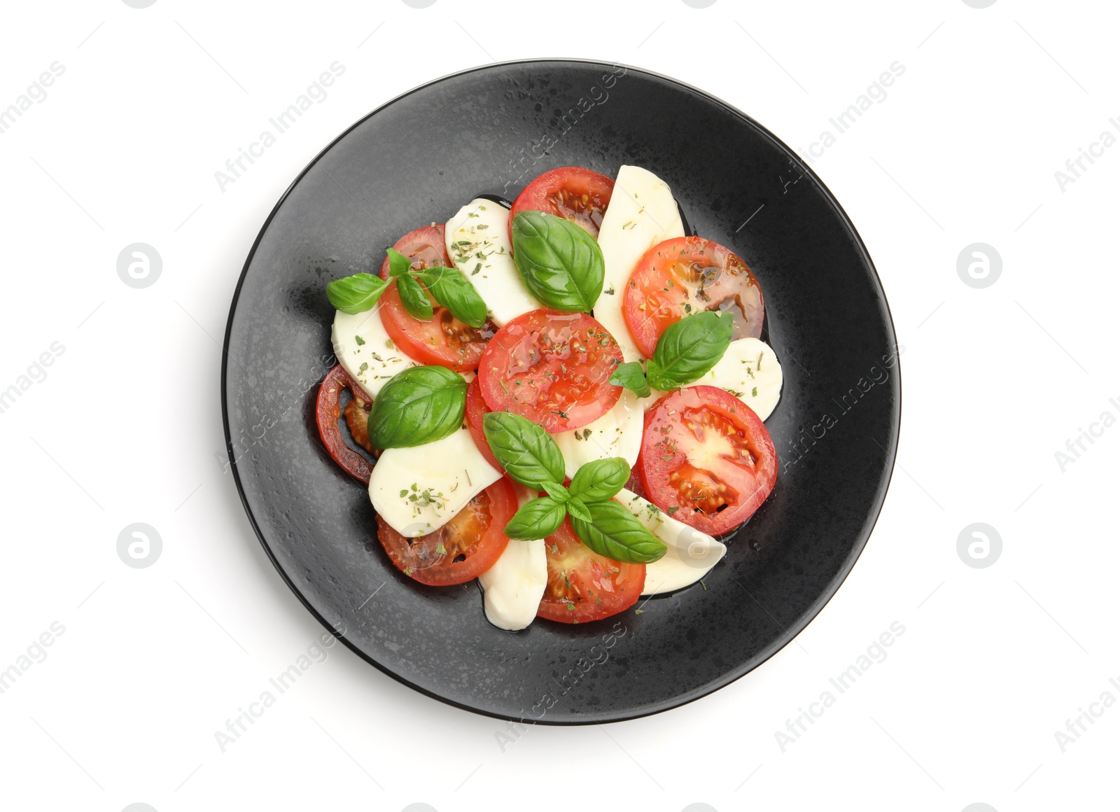 Tasty salad Caprese with mozzarella, tomatoes, basil and spices isolated on white, top view Photo of Tasty salad Caprese with mozzarella, tomatoes, basil and spices isolated on white, top view