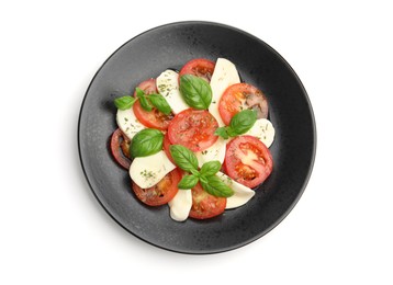 Photo of Tasty salad Caprese with mozzarella, tomatoes, basil and spices isolated on white, top view