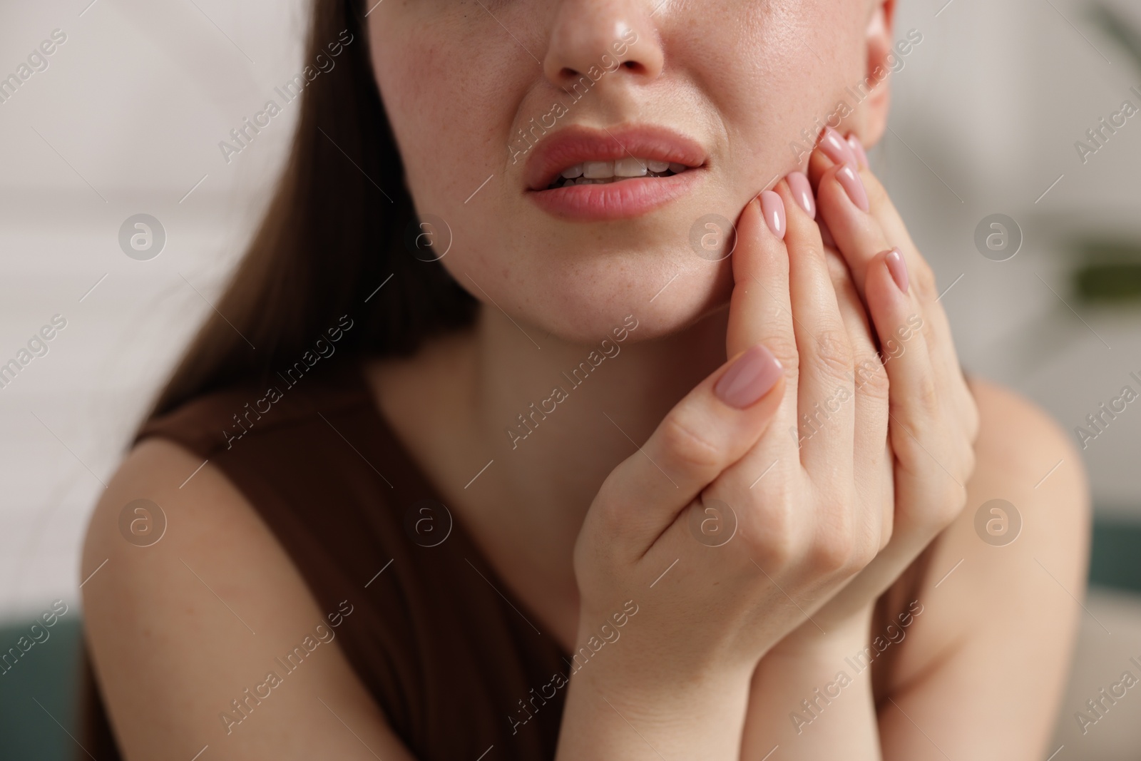 Woman suffering from toothache at home, closeup Photo of Woman suffering from toothache at home, closeup