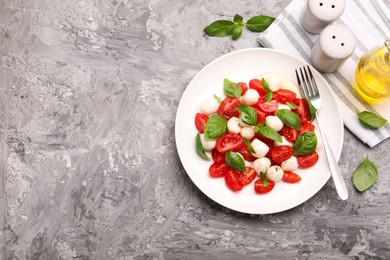 Photo of Tasty salad Caprese served on grey table, flat lay. Space for text