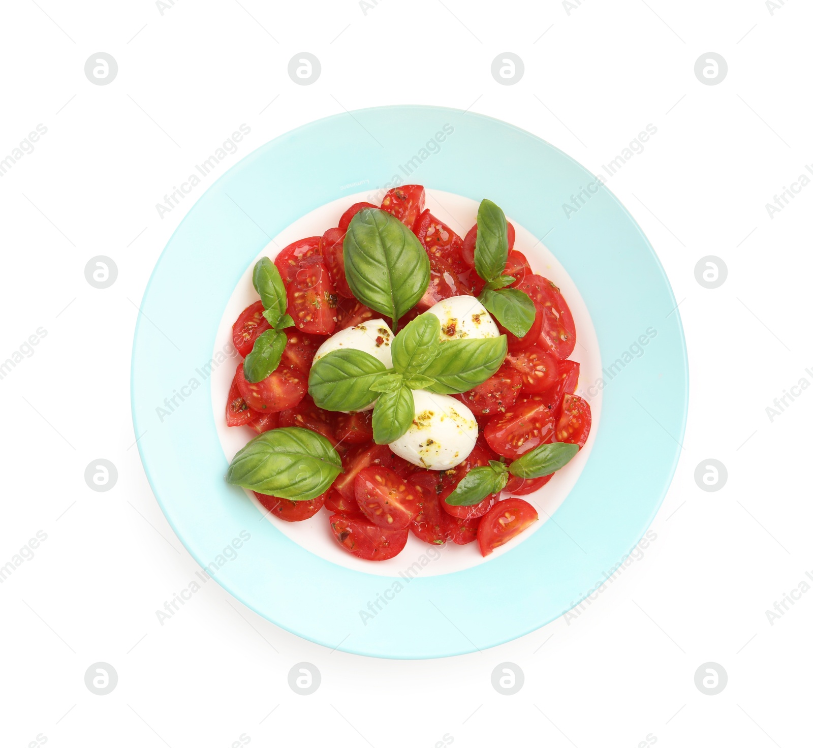 Photo of Tasty salad Caprese with mozzarella, tomatoes, basil and spices isolated on white, top view