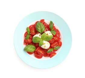 Photo of Tasty salad Caprese with mozzarella, tomatoes, basil and spices isolated on white, top view