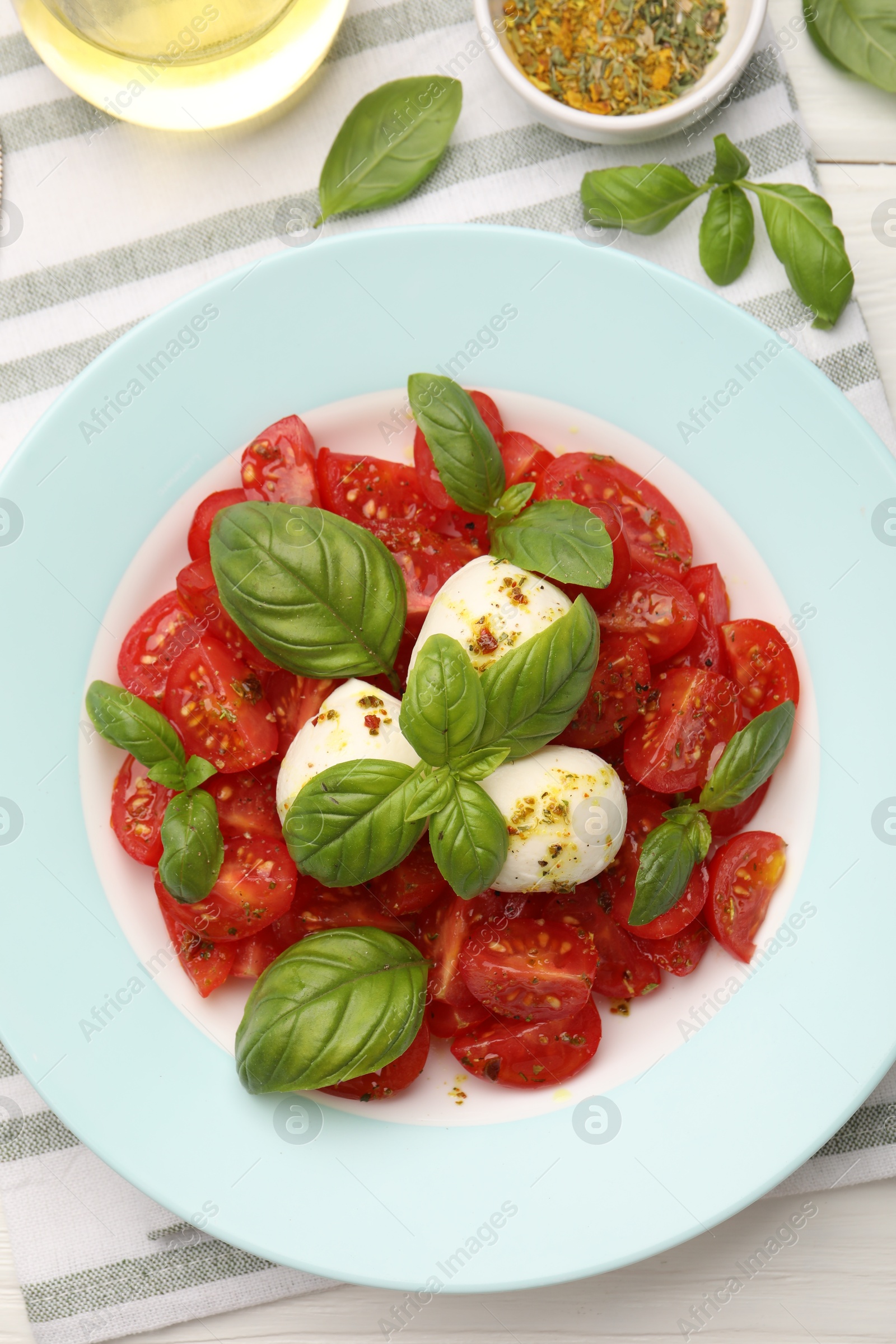 Photo of Tasty salad Caprese served on table, flat lay