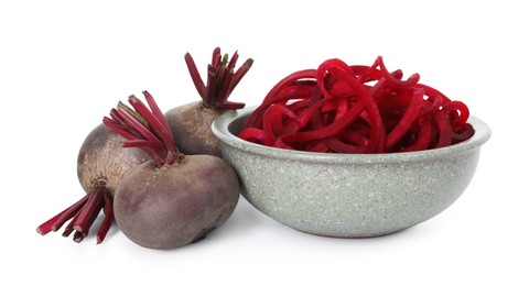 Photo of Raw beetroot noodles and fresh vegetables isolated on white. Vegetarian dish