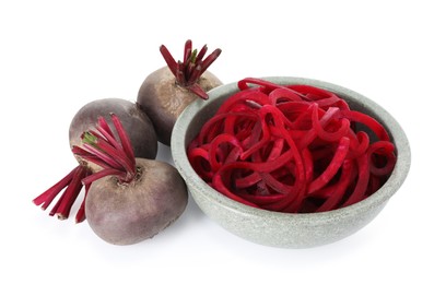 Photo of Raw beetroot noodles and fresh vegetables isolated on white. Vegetarian dish